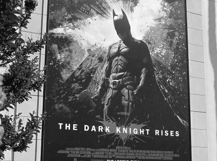 A poster for the Warner Bros. film "The Dark Knight Rises" is displayed at Warner Bros. studios in Burbank, California, July 20, 2012.  A gunman in a gas mask and bullet-proof vest killed 12 people at a midnight premiere of the new "Batman" movie in a suburb of Denver early on Friday, sparking pandemonium when he hurled a gas canister into the auditorium and opened fire on moviegoers.  The attack injured 55 others including children during a screening of "The Dark Knight Rises" at a mall in the suburb of Aurora. REUTERS/Fred Prouser (UNITED STATES - Tags: ENTERTAINMENT CRIME LAW)