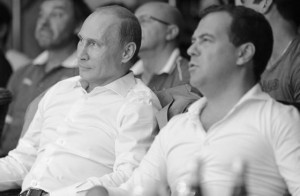 In this Saturday, Aug. 17, 2013 photo Russian President Vladimir Putin, left, and Russian Prime Minister Dmitry Medvedev watch League S - 70 professional fighting competition at Russia's Black Sea resort of Sochi. (AP Photo/RIA Novosti Kremlin, Mikhail Klimentyev, Presidential Press Service)