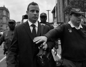 (140305) -- PRETORIA, March 5, 2014 (Xinhua) -- South African Paralympic athlete Oscar Pistorius (L) is escorted outside court during a recess on the third day of his trial at the high court in Pretoria, South Africa, March 5, 2014. Pistorius is charged with murder for the shooting death of his girlfriend, Reeva Steenkamp, on Valentines Day in 2013. (Xinhua/Philly)