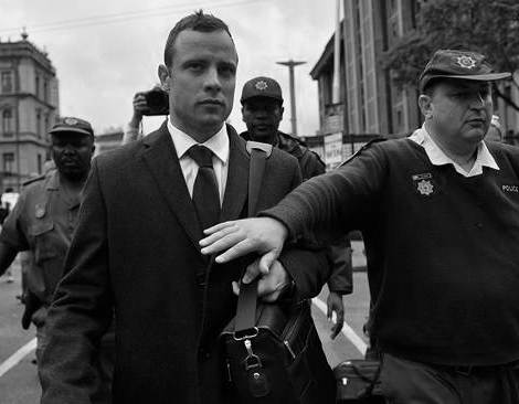 (140305) -- PRETORIA, March 5, 2014 (Xinhua) -- South African Paralympic athlete Oscar Pistorius (L) is escorted outside court during a recess on the third day of his trial at the high court in Pretoria, South Africa, March 5, 2014. Pistorius is charged with murder for the shooting death of his girlfriend, Reeva Steenkamp, on Valentines Day in 2013. (Xinhua/Philly)